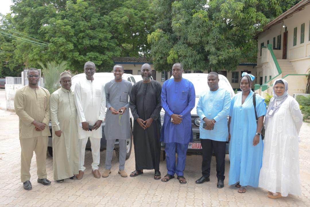 Group photograph at the official handover of four vehicles from GIRAV to NAWEC at the CPCU Complex, Banjul